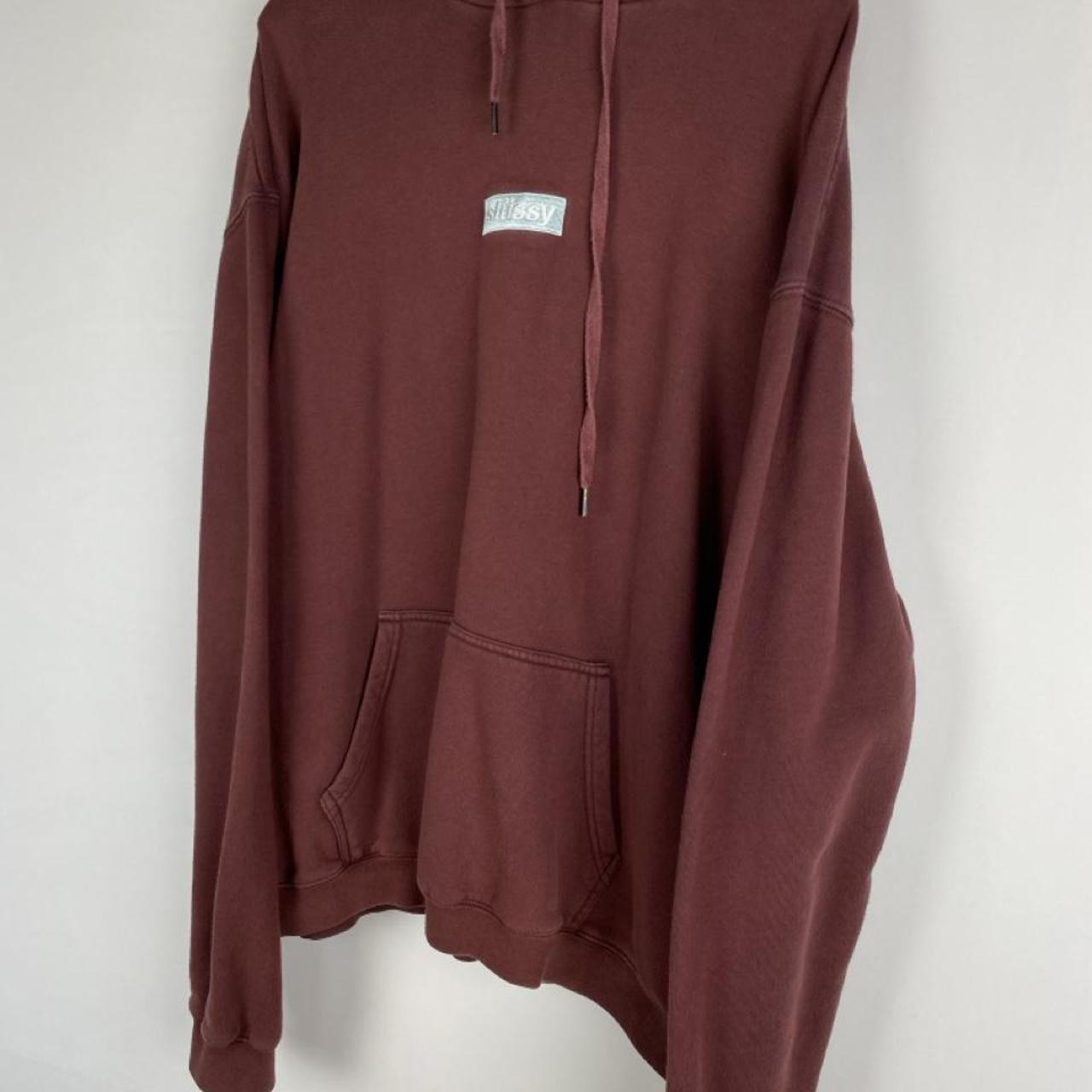 Stüssy oversized burgundy hoodie with embroidered box logo and relaxed fit.