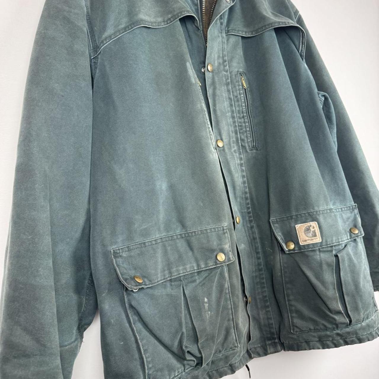 Carhartt oversized chore jacket in brown with classic logo patch and durable fabric.