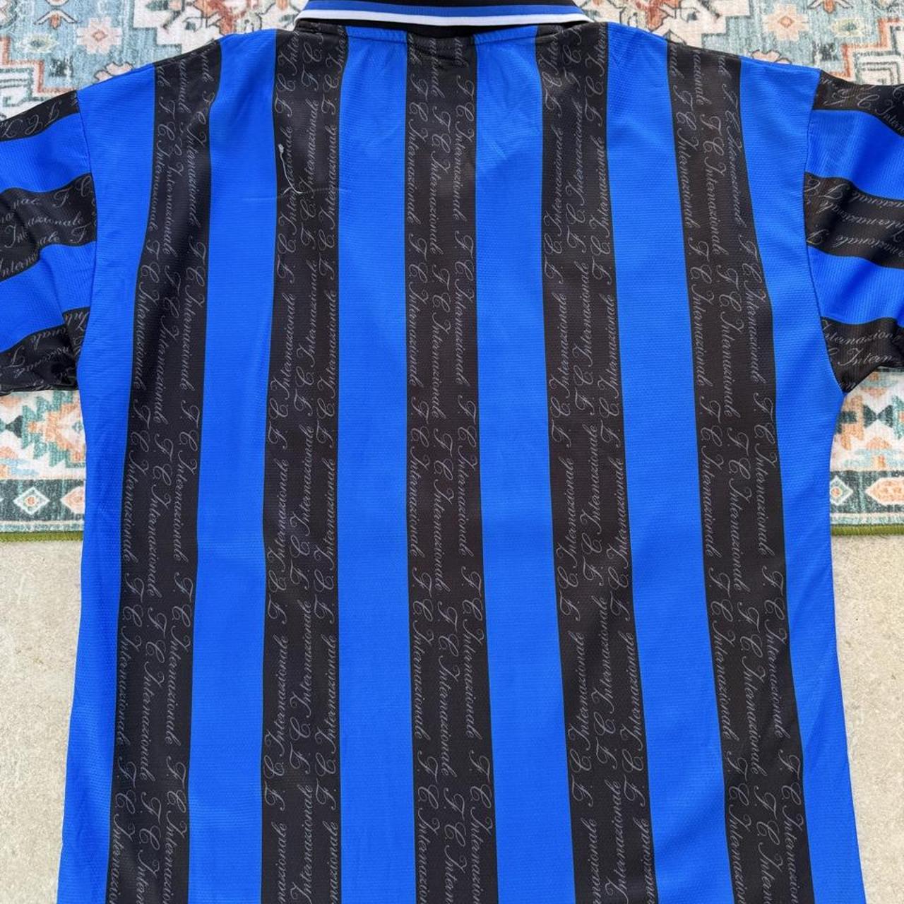 Umbro blue and navy striped home jersey with embroidered logo and vintage design.
