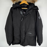 Canada Goose black parka jacket with logo patch and fur-trimmed hood.