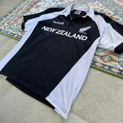 Kooga men's polo shirt, green with embroidered New Zealand logo and rugby collar.