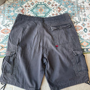 Oakley black cargo shorts with embroidered logo and tactical pockets.