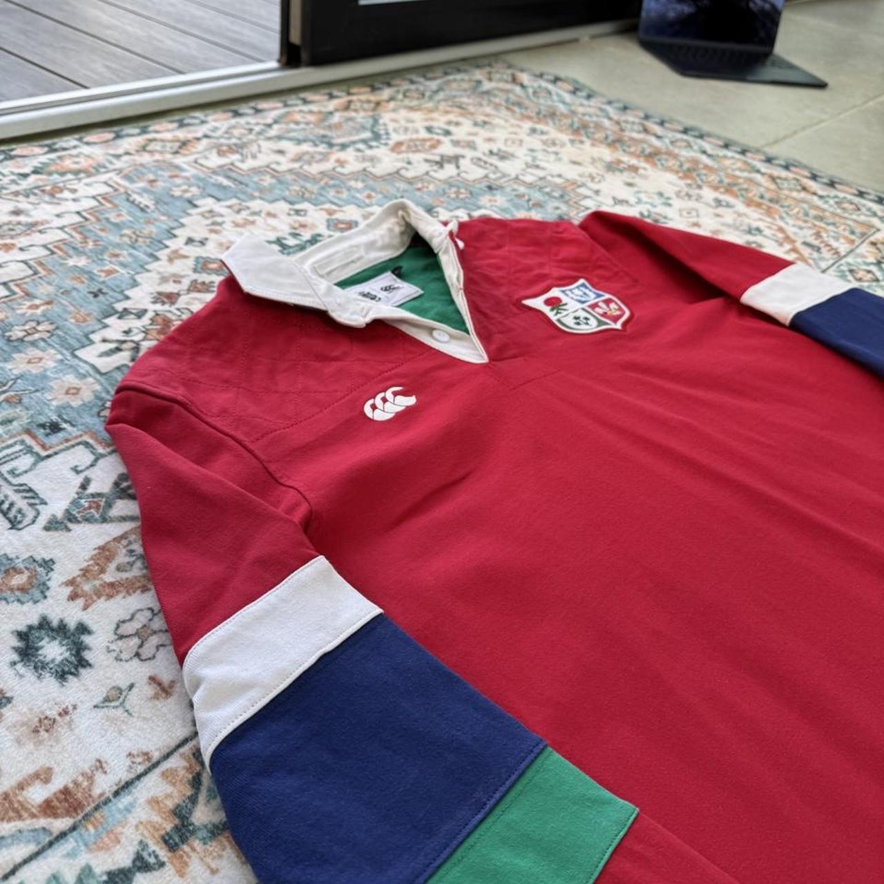 Canterbury men's rugby polo red with British and Irish Lions logo and embroidered details.