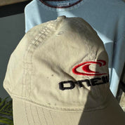 O'Neill cream hat with embroidered logo and vintage design details.