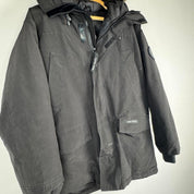 Canada Goose black parka jacket with logo patch and fur-trimmed hood.
