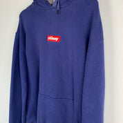 Stüssy blue oversized hoodie with embroidered box logo spellout on front.
