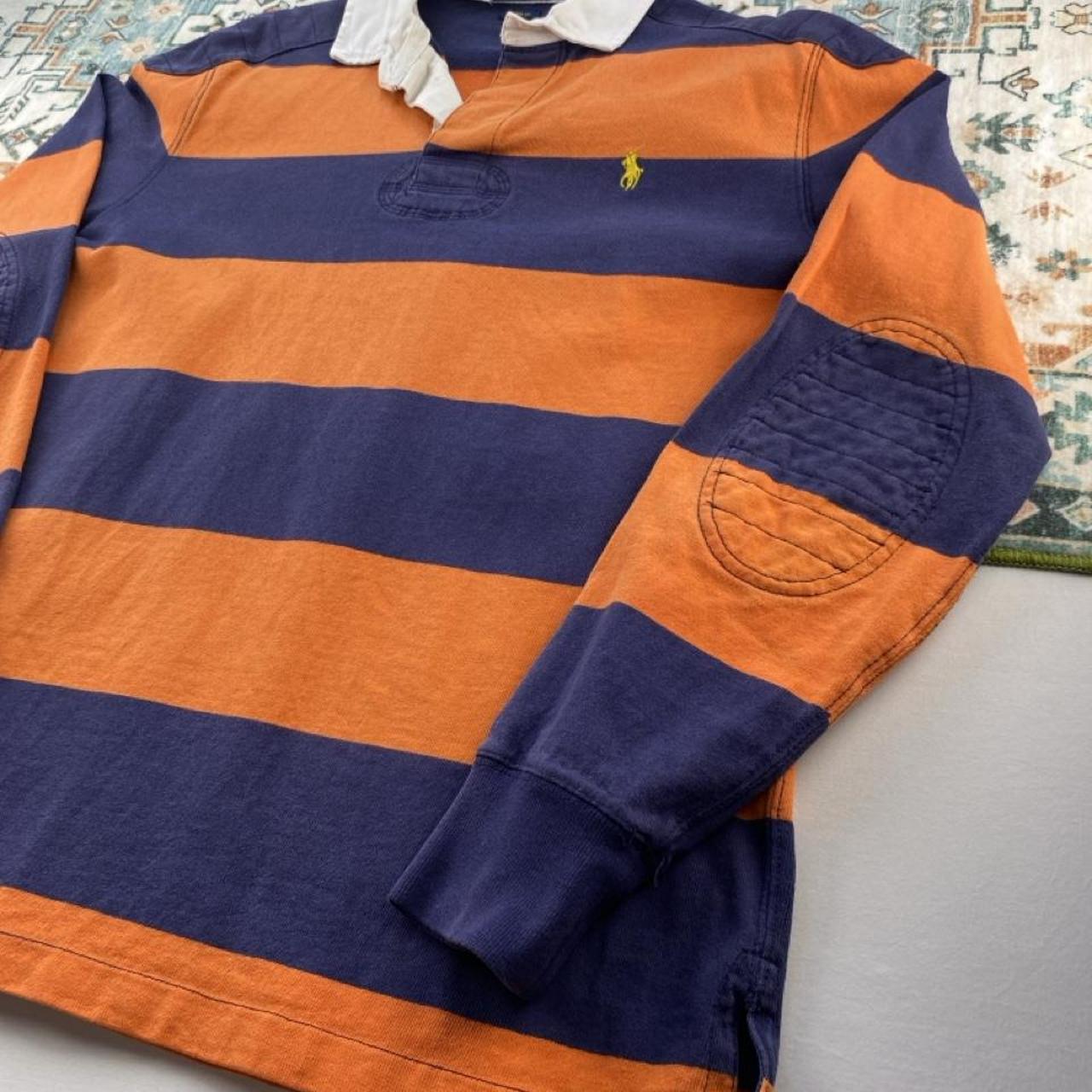 Polo Ralph Lauren navy and orange rugby polo shirt with thick stripes and embroidered logo.