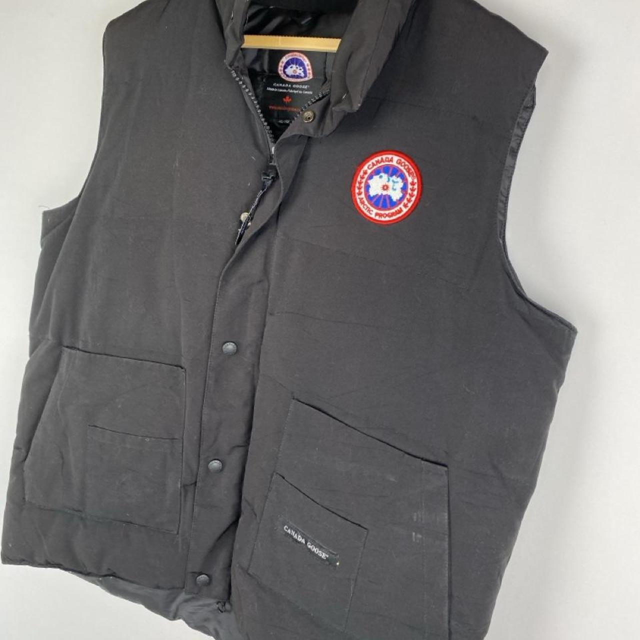 Canada Goose black down filled gilet with logo patch and zippered pockets.