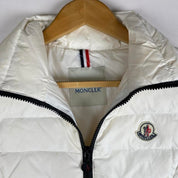 Moncler white down puffer gilet with logo detail and missing belt.