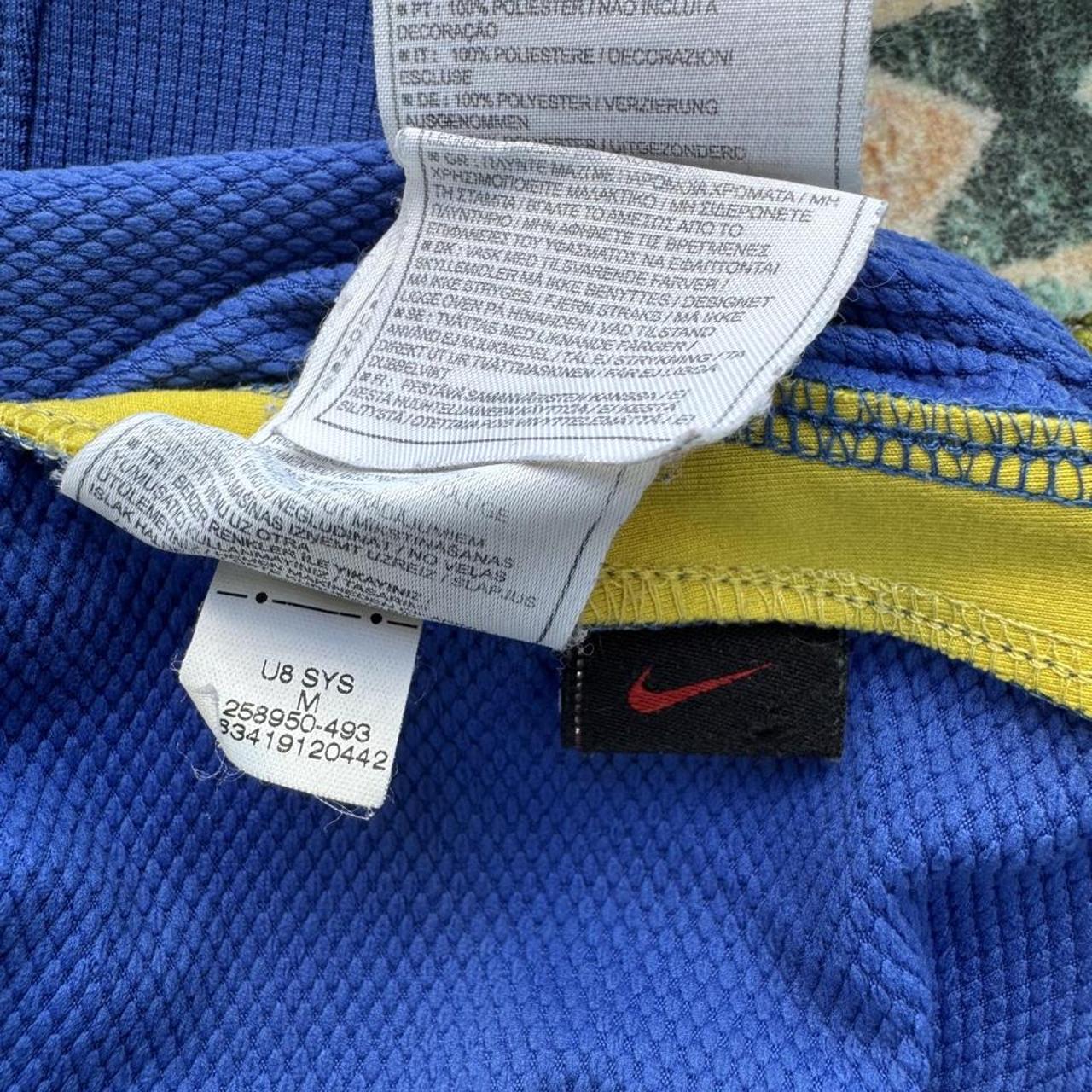 Nike blue Brazil away jersey with logo and classic design details.