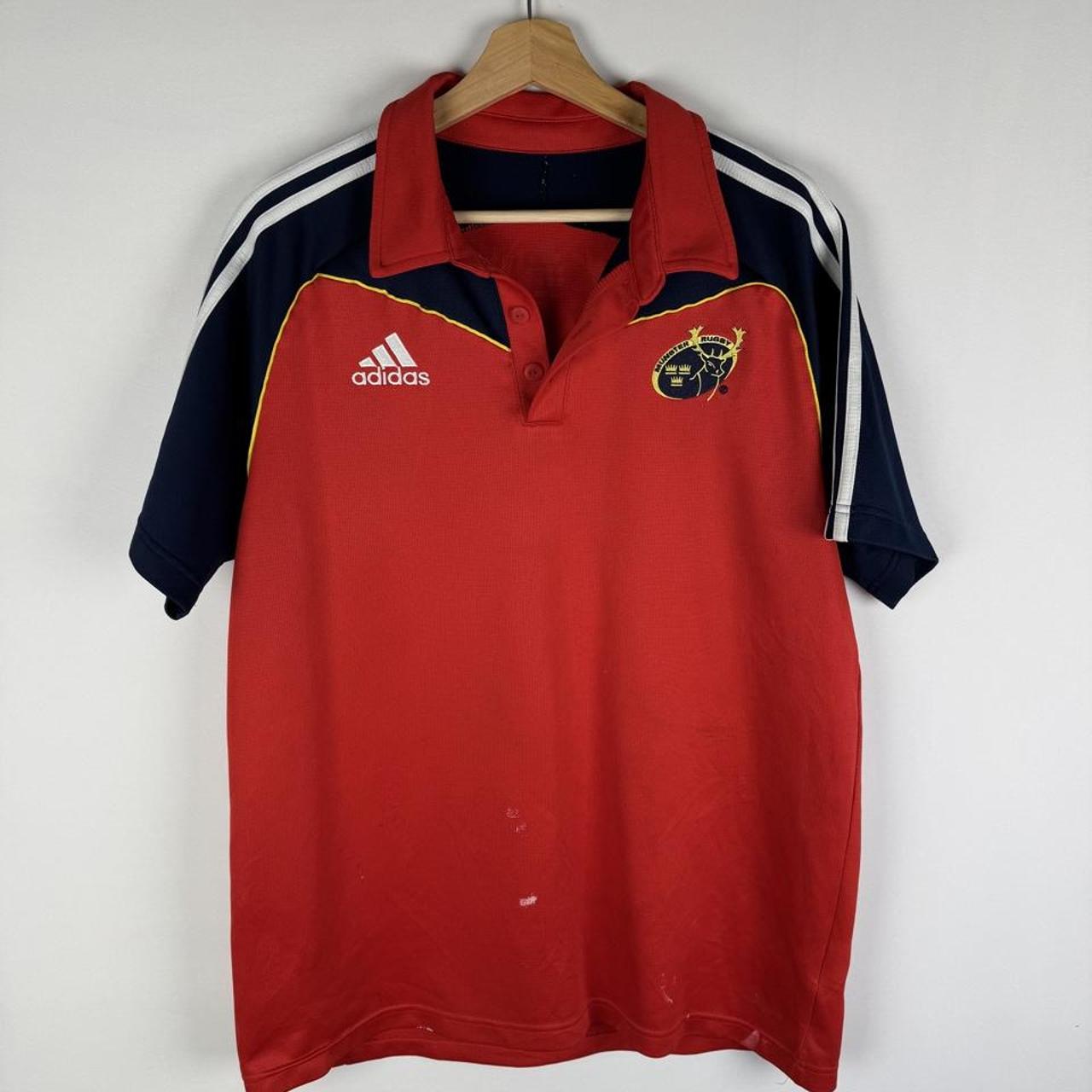 Adidas men's polo shirt in green with embroidered logo and classic collar.