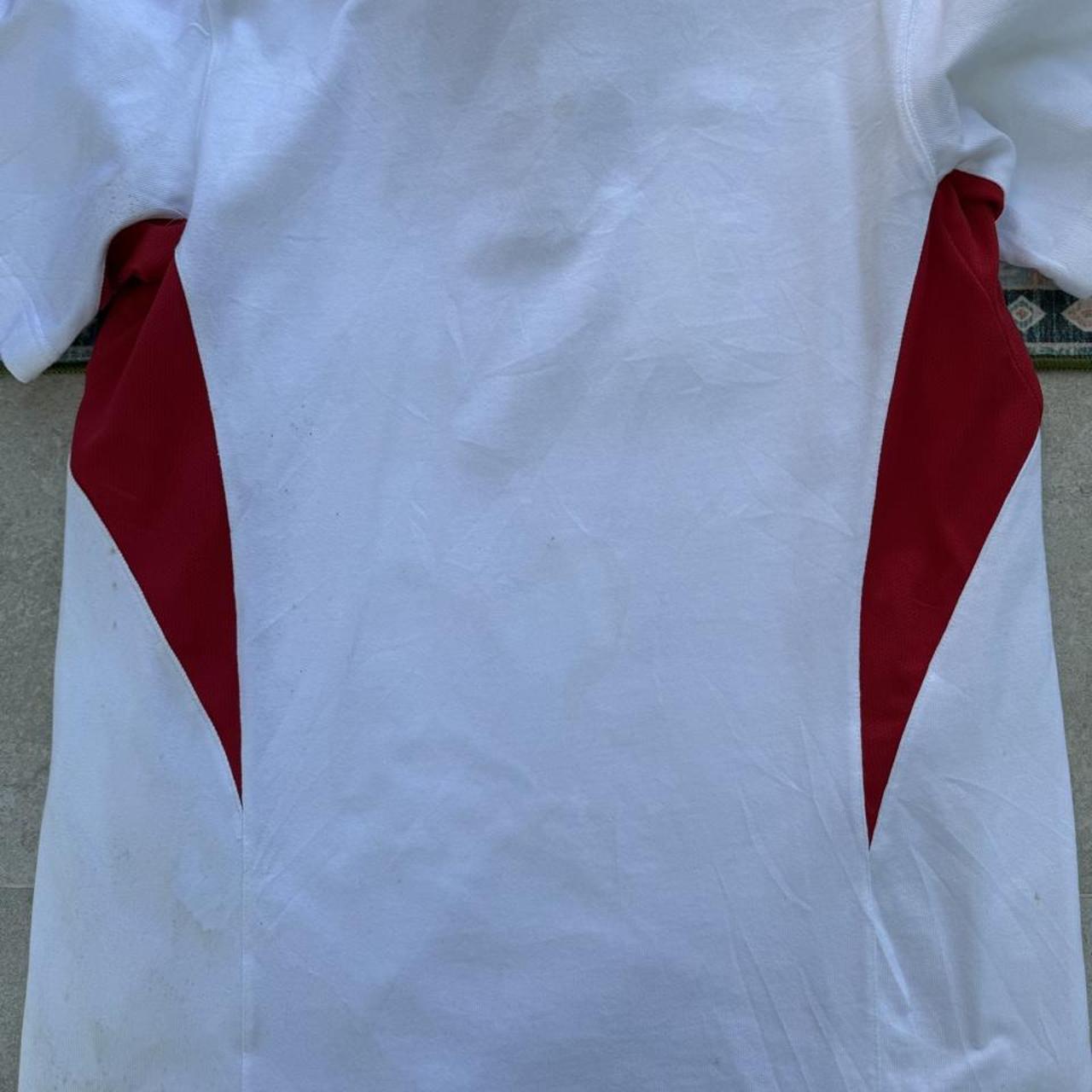 Nike England rugby polo shirt, red with embroidered logo and white collar details.