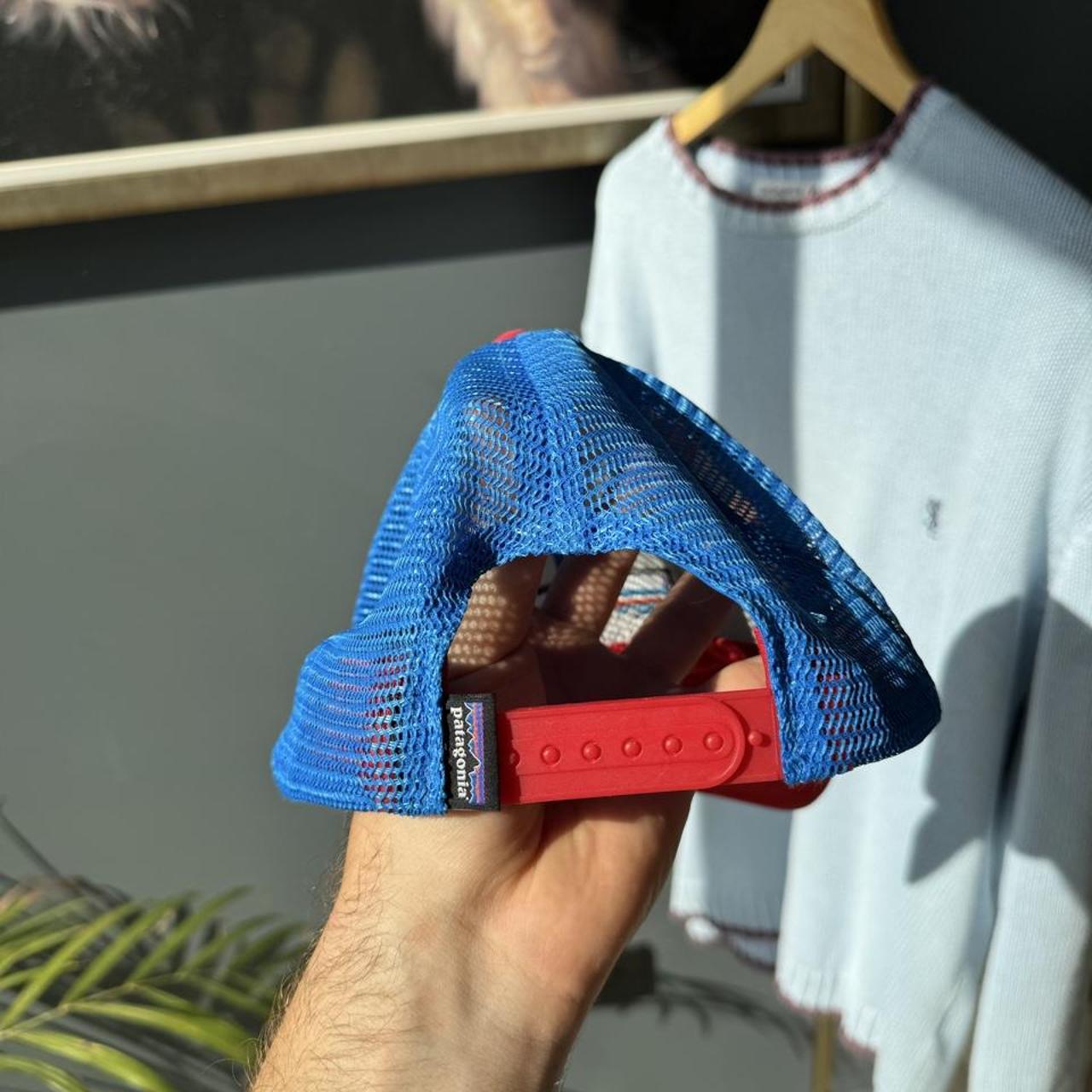Patagonia cream trucker cap with embroidered logo and mesh back.