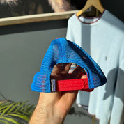 Patagonia cream trucker cap with embroidered logo and mesh back.