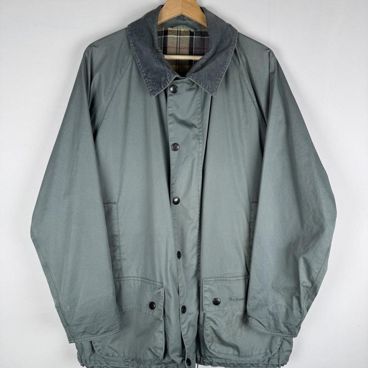 Barbour blue lightweight Beaufort jacket with subtle marks and classic logo detail.