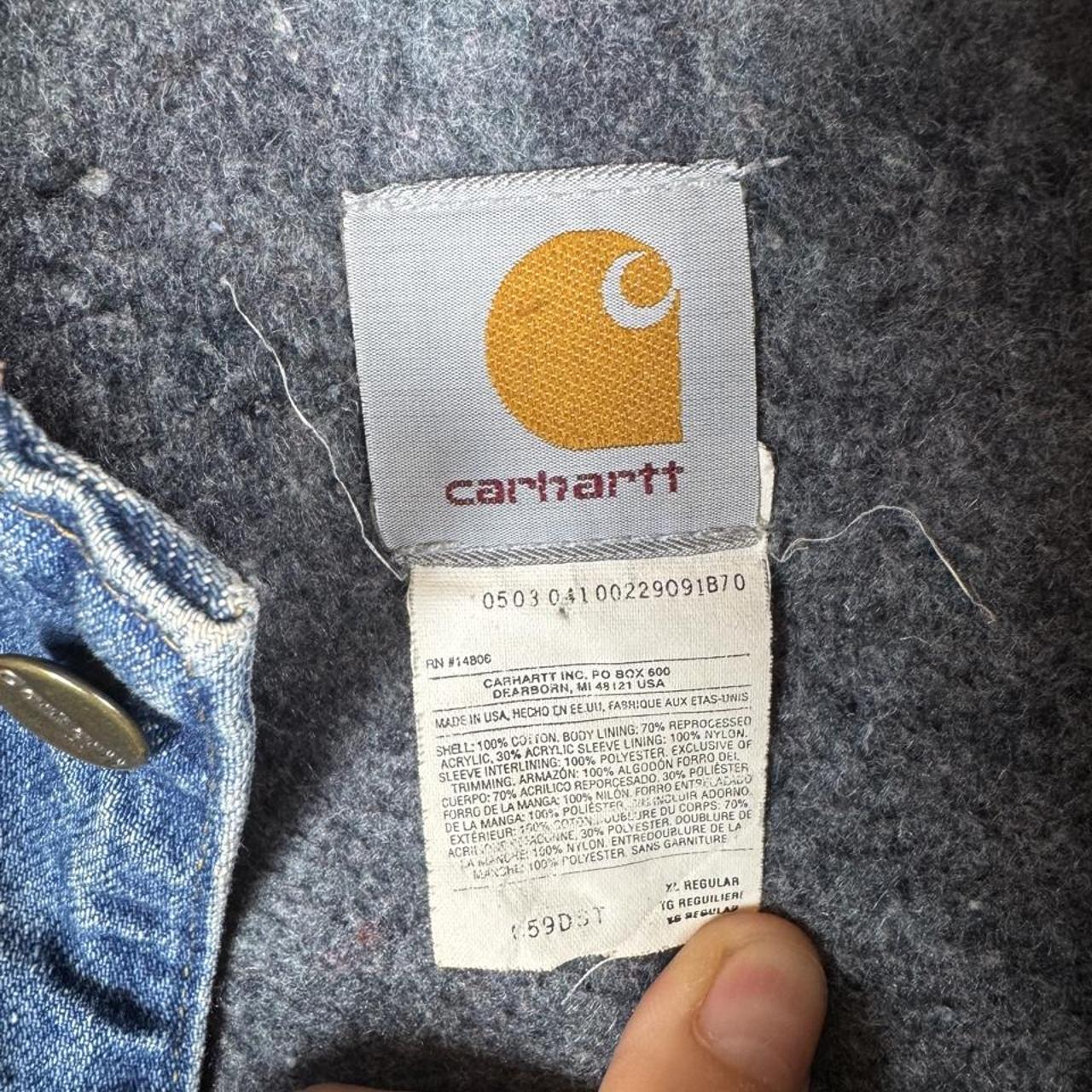 Carhartt denim chore jacket oversized 1990s style with classic logo and blue wash.