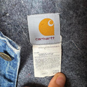 Carhartt denim chore jacket oversized 1990s style with classic logo and blue wash.