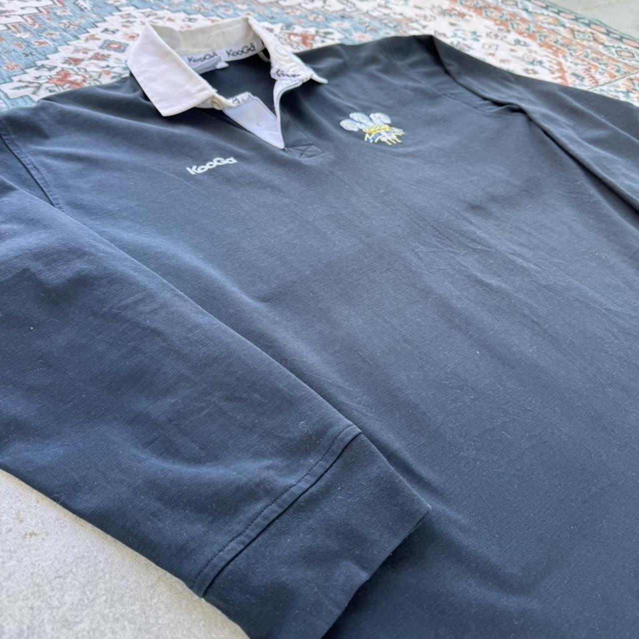 Kooga men's polo shirt in Prince of Wales pattern, featuring logo and regular fit.