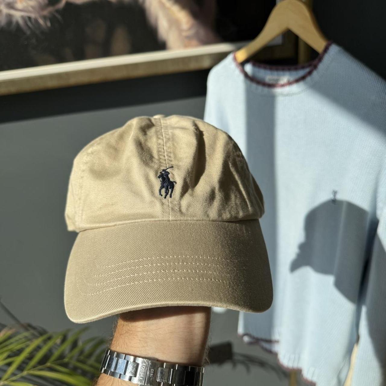 Polo Ralph Lauren beige cap with embroidered pony logo and adjustable strap.