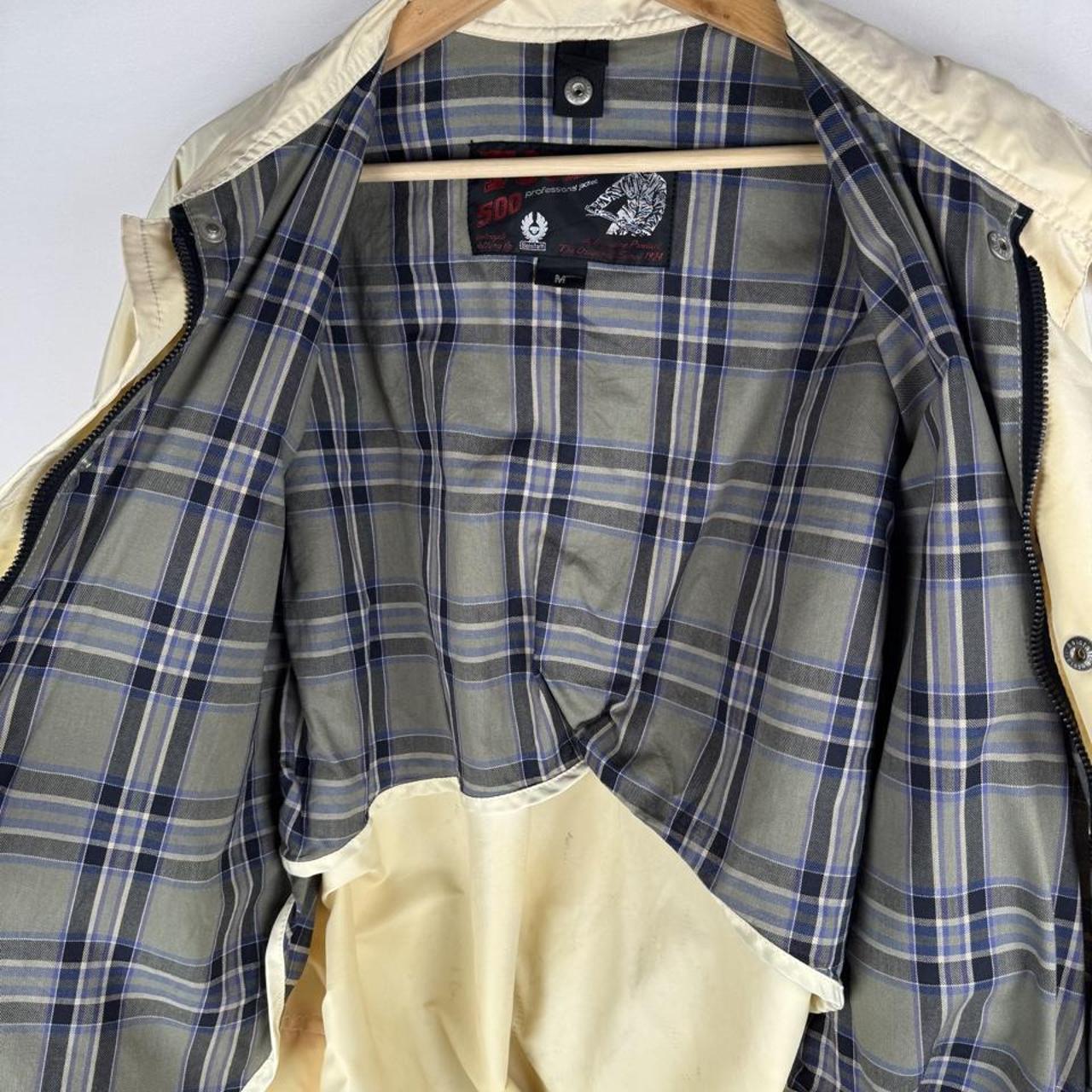 Belstaff cream motorcycle jacket with logo patch and shell material details.