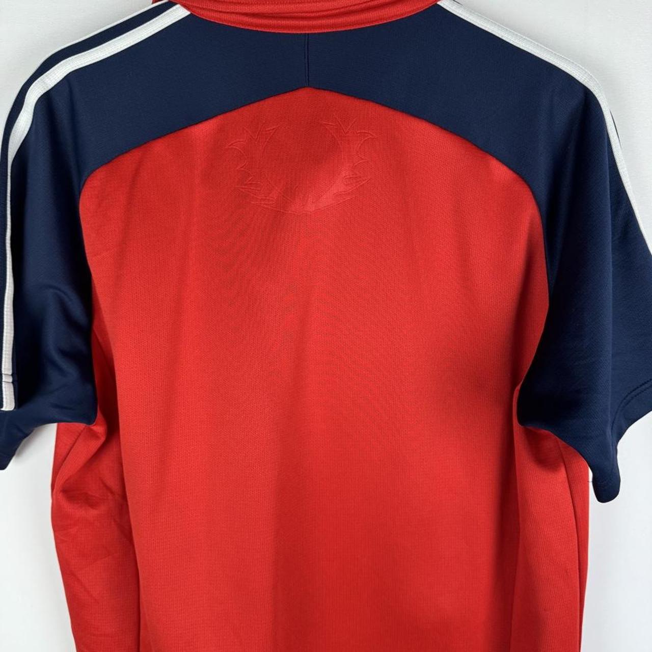 Adidas men's polo shirt in green with embroidered logo and classic collar.