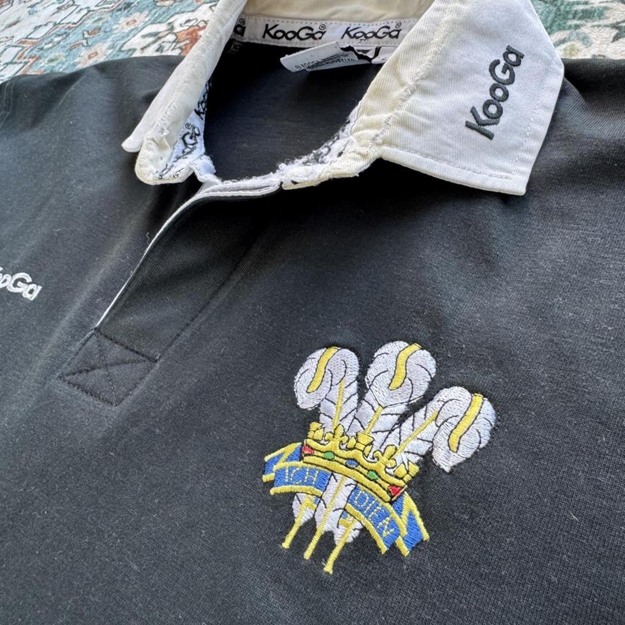 Kooga men's polo shirt in Prince of Wales pattern, featuring logo and regular fit.