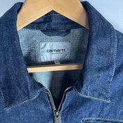 Carhartt WIP blue denim jacket with logo patch and classic design details.