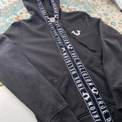 True Religion black and white full zip hoodie with logo and contrast stitching.