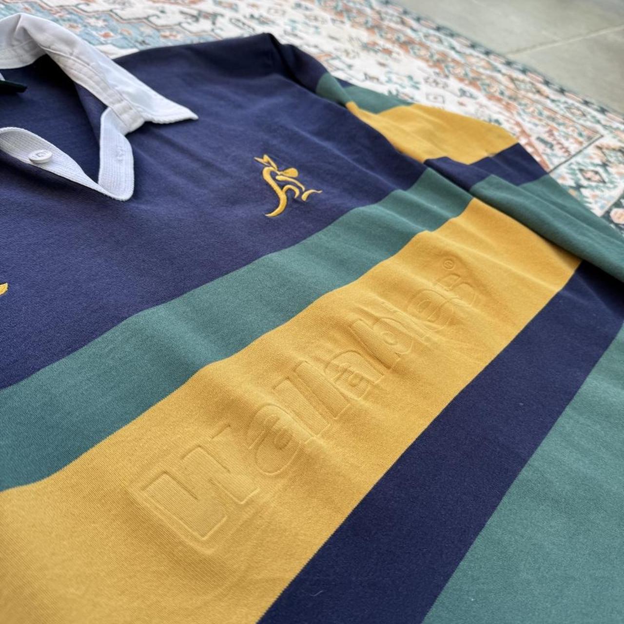 Canterbury men's long sleeve rugby polo green with Australia Wallabies logo and embroidered details.