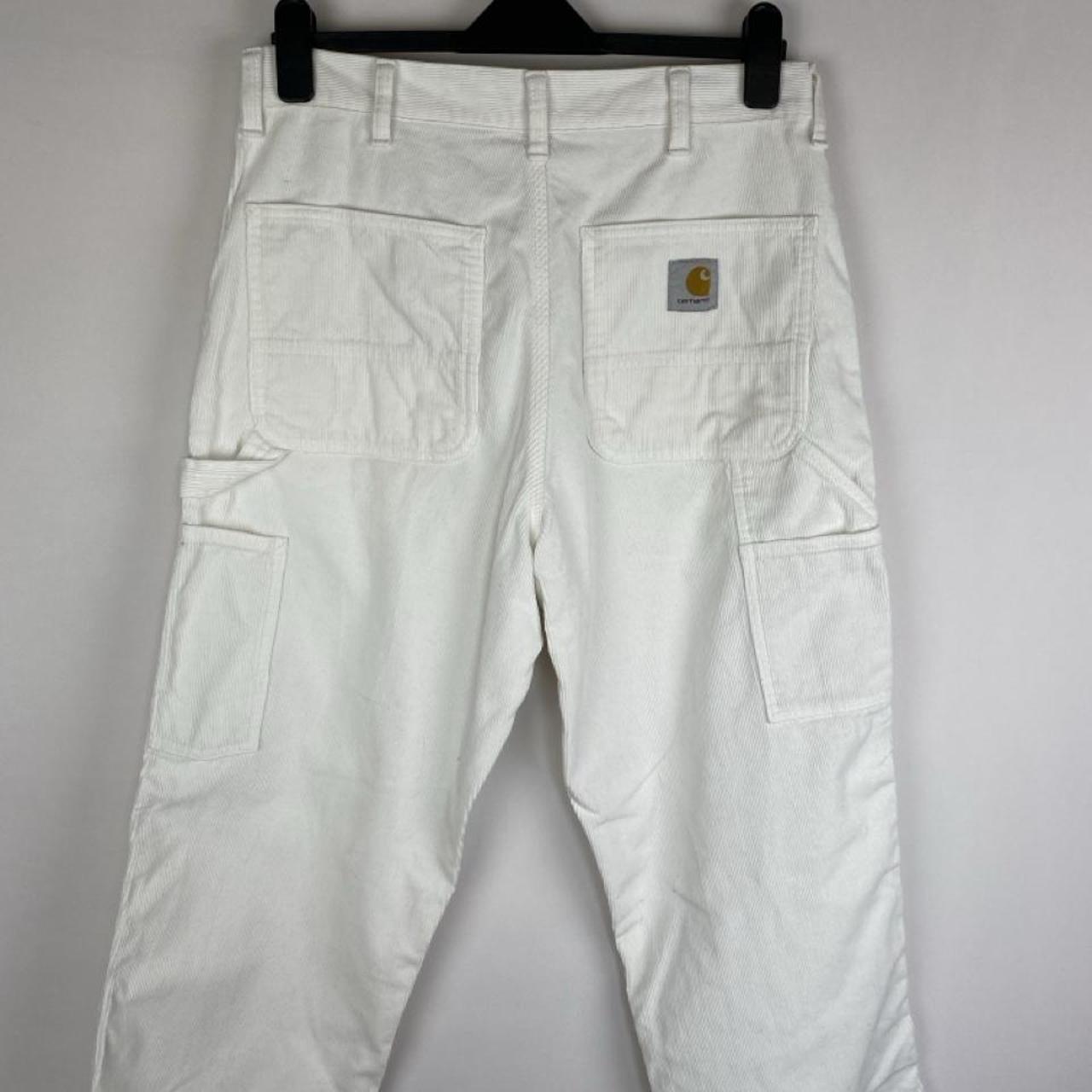Carhartt WIP white corduroy carpenter trousers with single knee design and relaxed fit.