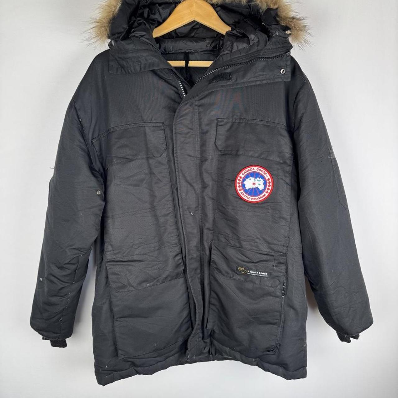 Canada Goose black and brown parka jacket with logo and utility pockets.