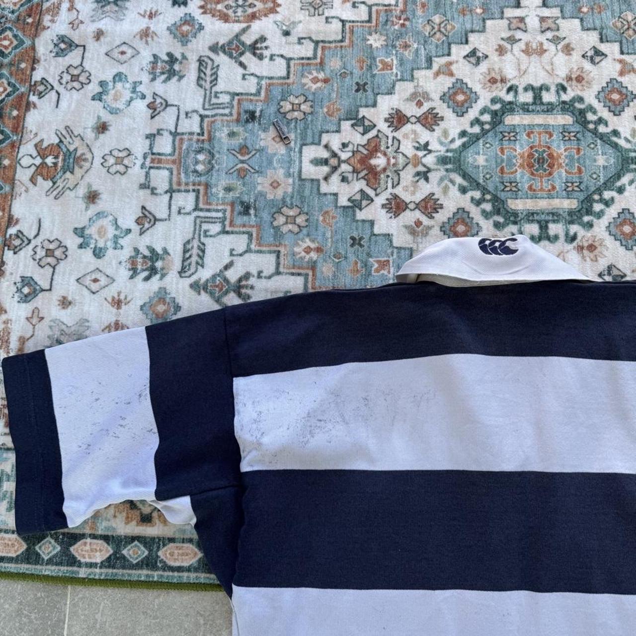 Canterbury men's rugby polo shirt, navy blue, featuring Harper Adams University logo and classic collar.
