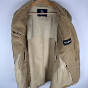 Burberry cream corduroy blazer with subtle logo details and a slim fit design.
