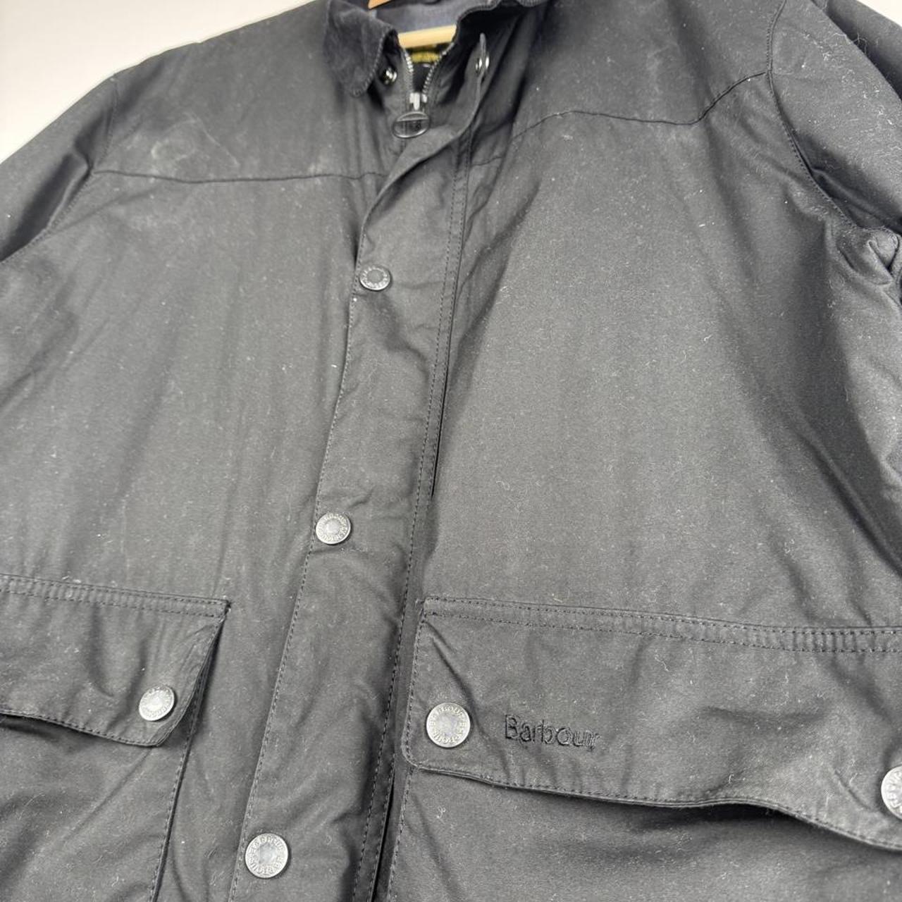 Barbour black wax jacket with logo detail and classic design, size XXL.