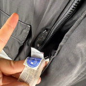 Canada Goose battered jacket black with no fur, badge, or visible holes.