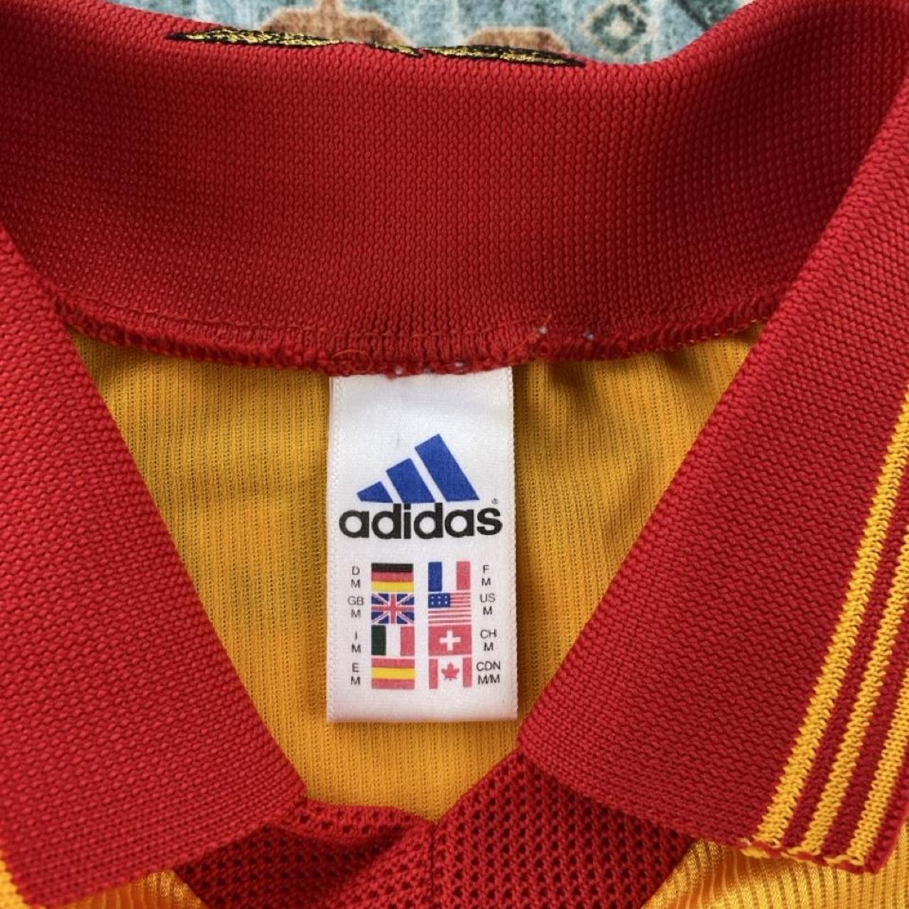 Adidas orange Benfica away jersey with embroidered logo and vintage design details.