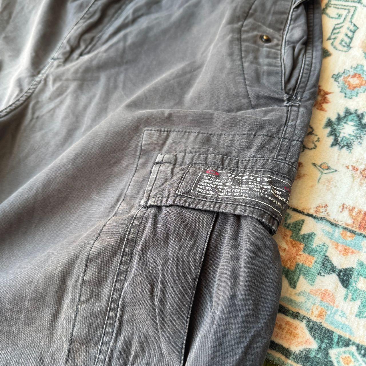 Oakley black cargo shorts with embroidered logo and tactical pockets.