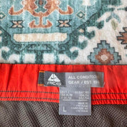 Nike ACG grey cargo shorts with multiple pockets and embroidered logo detail.