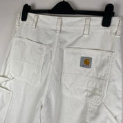 Carhartt WIP white corduroy carpenter trousers with single knee design and relaxed fit.