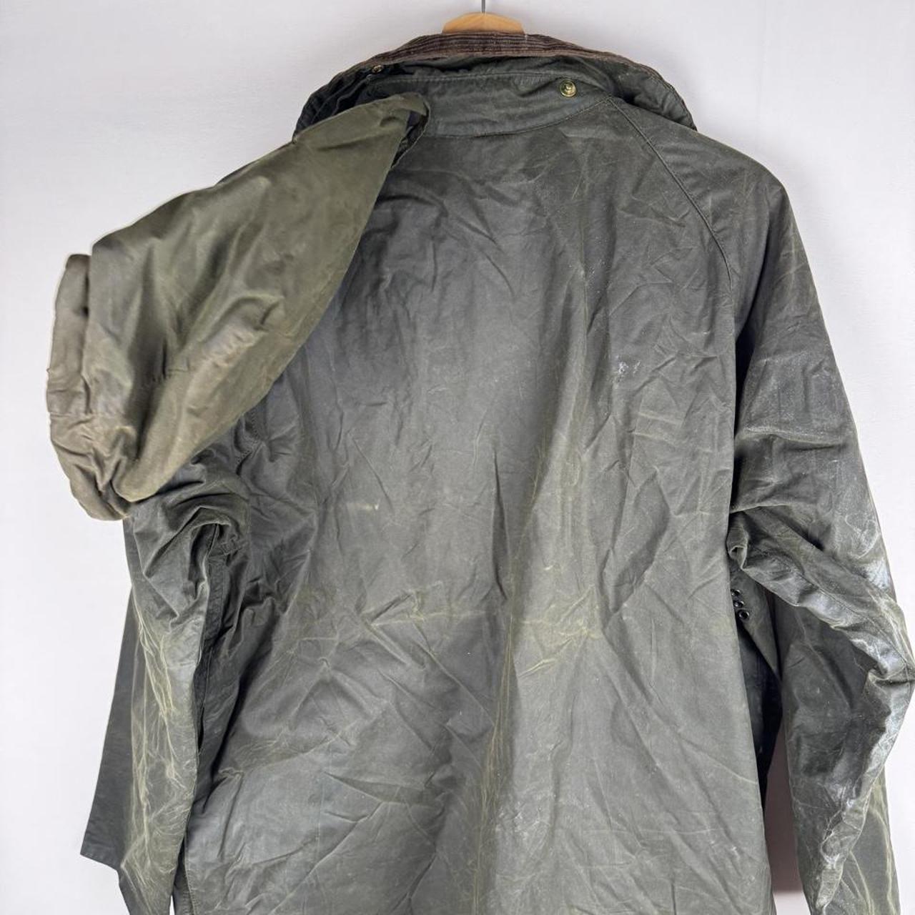 Barbour green waxed Beaufort jacket with attached hood and classic logo detail.