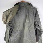 Barbour green waxed Beaufort jacket with attached hood and classic logo detail.