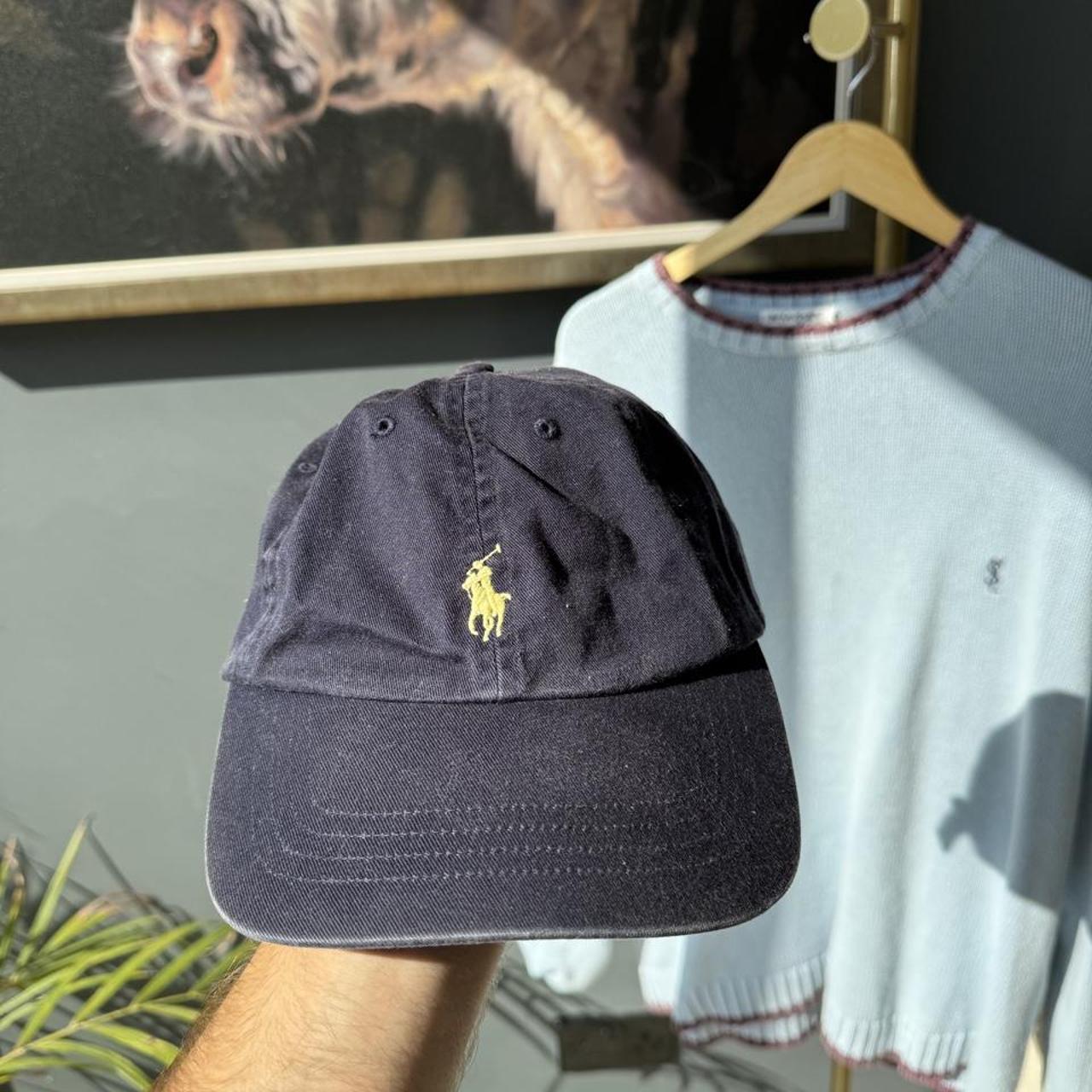 Polo Ralph Lauren navy hat with embroidered logo and adjustable strap.