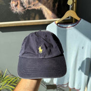 Polo Ralph Lauren navy hat with embroidered logo and adjustable strap.