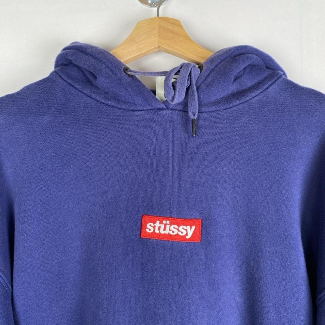Stüssy blue oversized hoodie with embroidered box logo spellout on front.