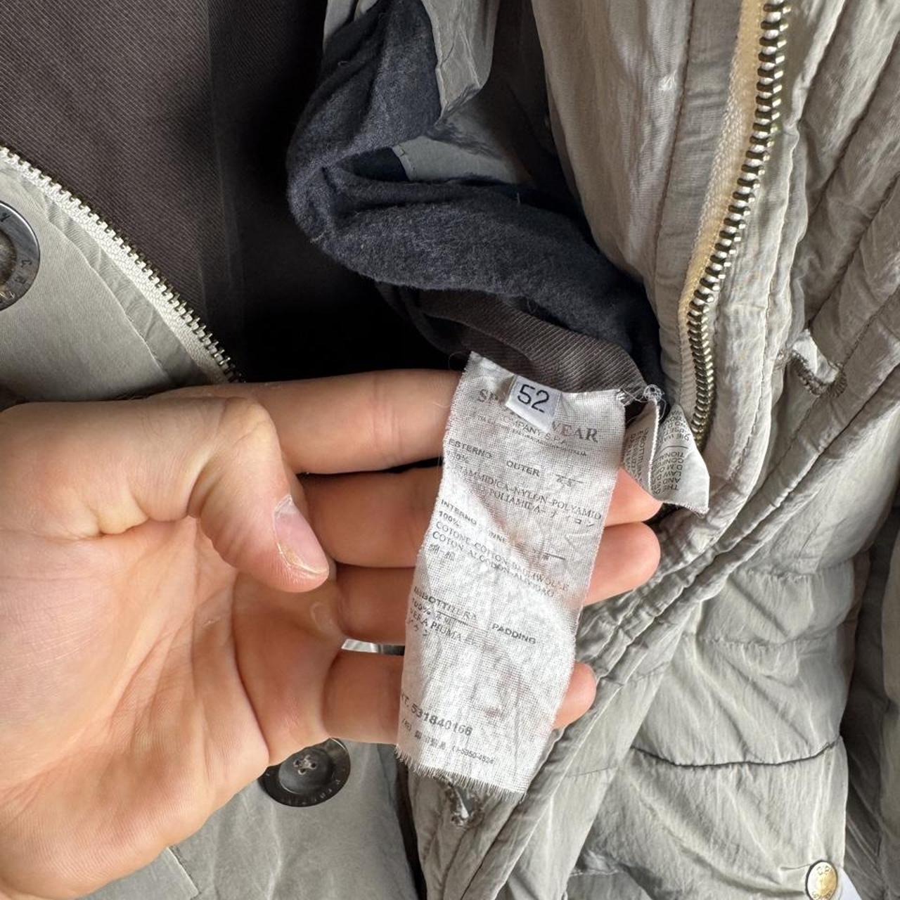 CP Company multi-colour utility parka jacket with multiple pockets and hood.