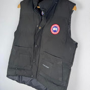 Canada Goose black puffer gilet with logo patch and quilted design.