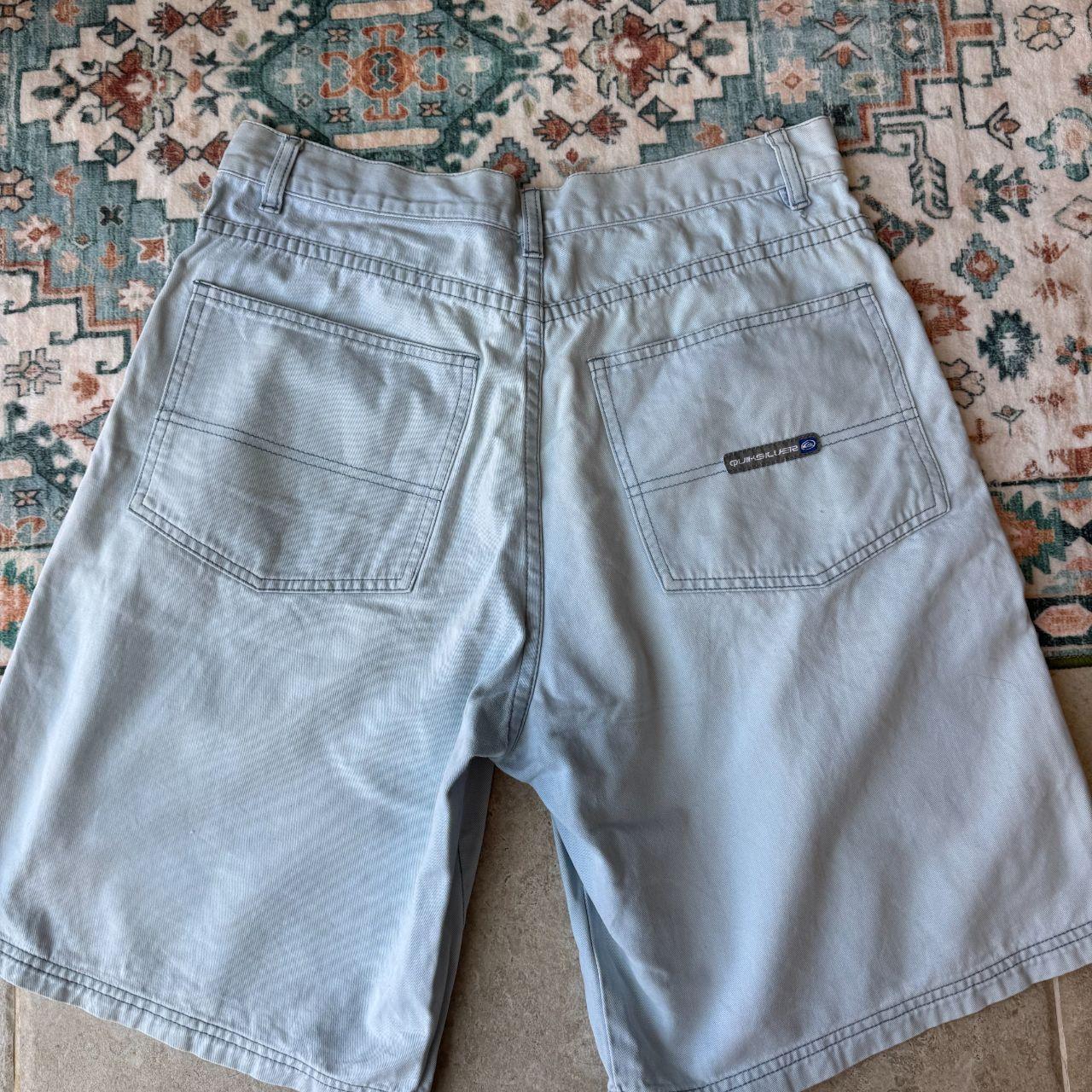 Quiksilver baby blue surf shorts 100% cotton with logo and classic design details.