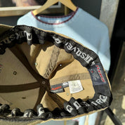 Quiksilver cream cap with embroidered surf logo and adjustable strap.