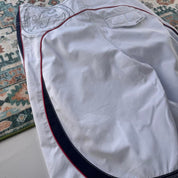 Billabong board shorts blue with embroidered Taj Burrow signature and tropical pattern.