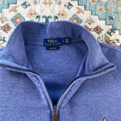 Polo Ralph Lauren light blue quarter zip fleece with embroidered logo and soft texture.